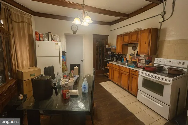 a kitchen with refrigerator stove and sink