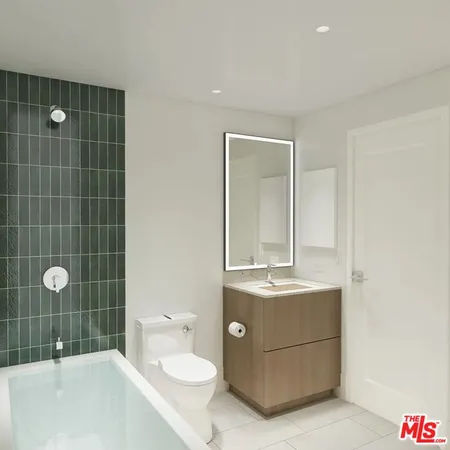 a bathroom with a sink a toilet and mirror