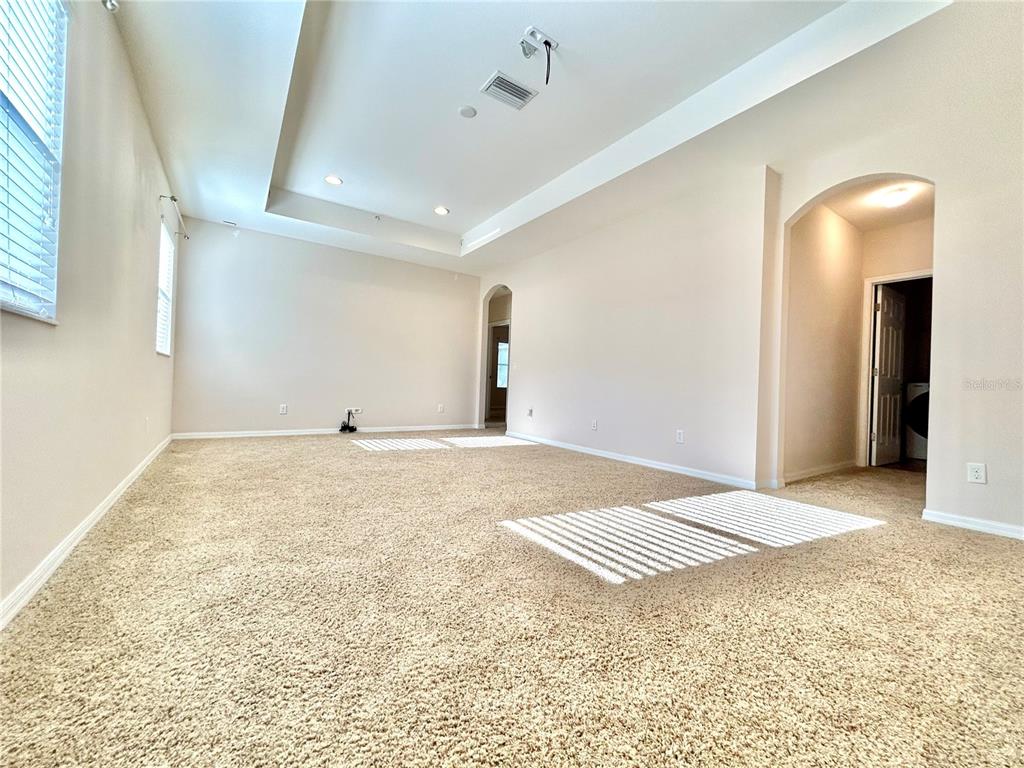 11210 Roseate Drive Tampa, FL 33626 - Photo 16 of 50 a view of a livingroom with wooden floor and bedroom