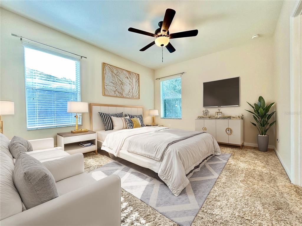 11210 Roseate Drive Tampa, FL 33626 - Photo 18 of 50 a spacious bedroom with a bed a couch and a window