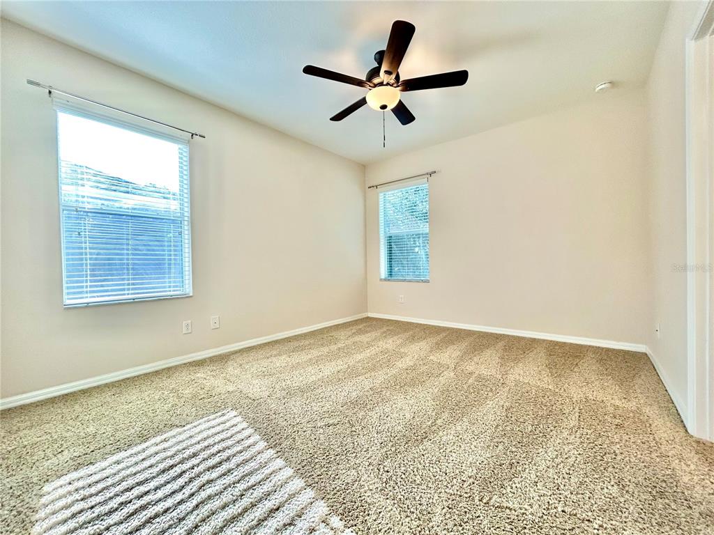 11210 Roseate Drive Tampa, FL 33626 - Photo 19 of 50 a view of a livingroom with a ceiling fan and window