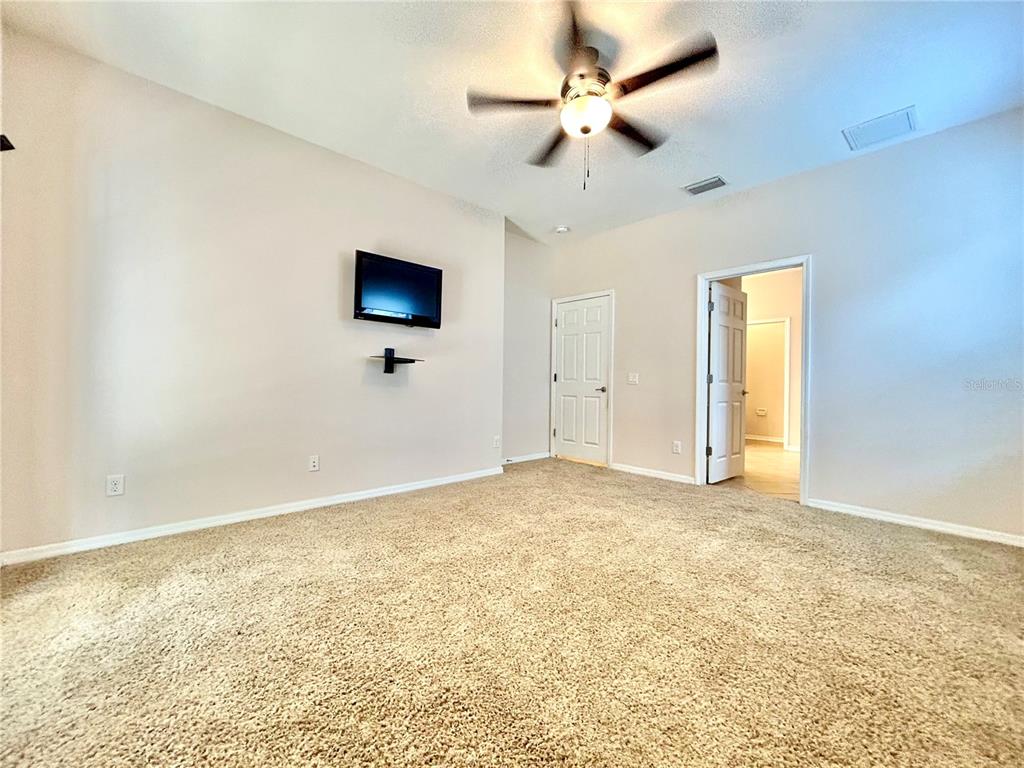 11210 Roseate Drive Tampa, FL 33626 - Photo 23 of 50 an empty room with a window and a ceiling fan