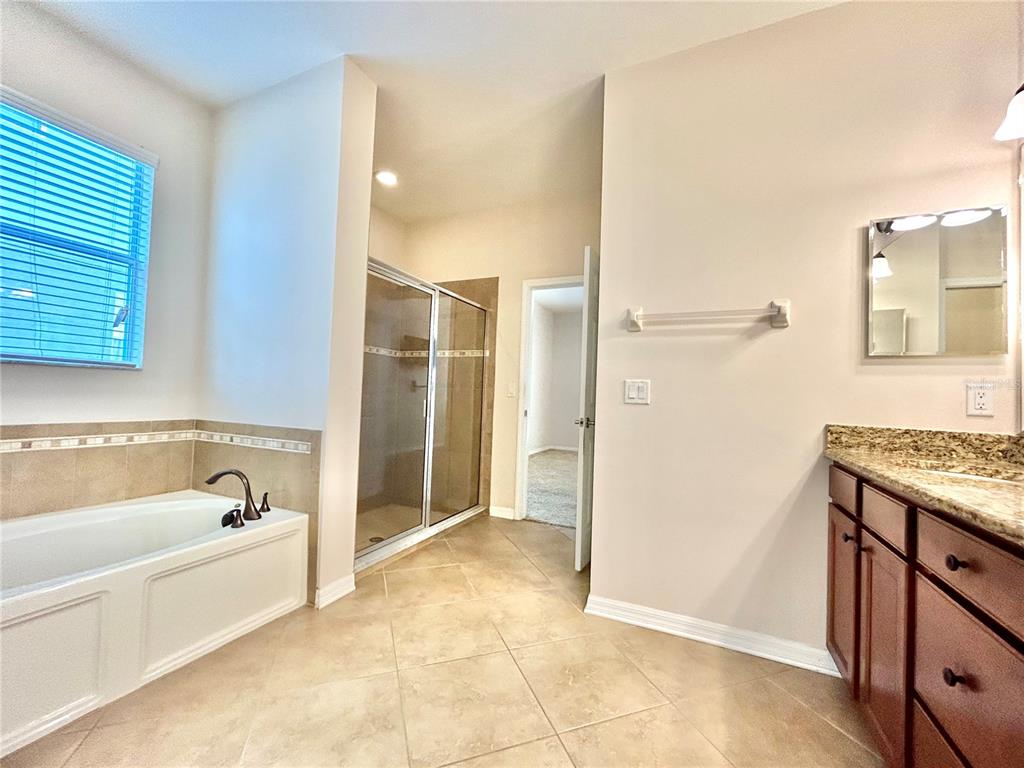 11210 Roseate Drive Tampa, FL 33626 - Photo 29 of 50 a bathroom with a bathtub and a shower
