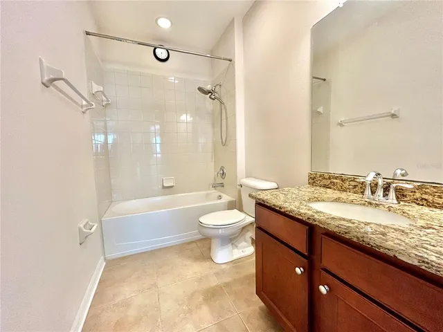 a bathroom with a granite countertop sink toilet a large mirror and shower