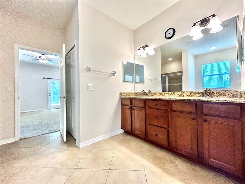 11210 Roseate Drive Tampa, FL 33626 - Photo 32 of 50 a bathroom with a granite countertop sink and a mirror
