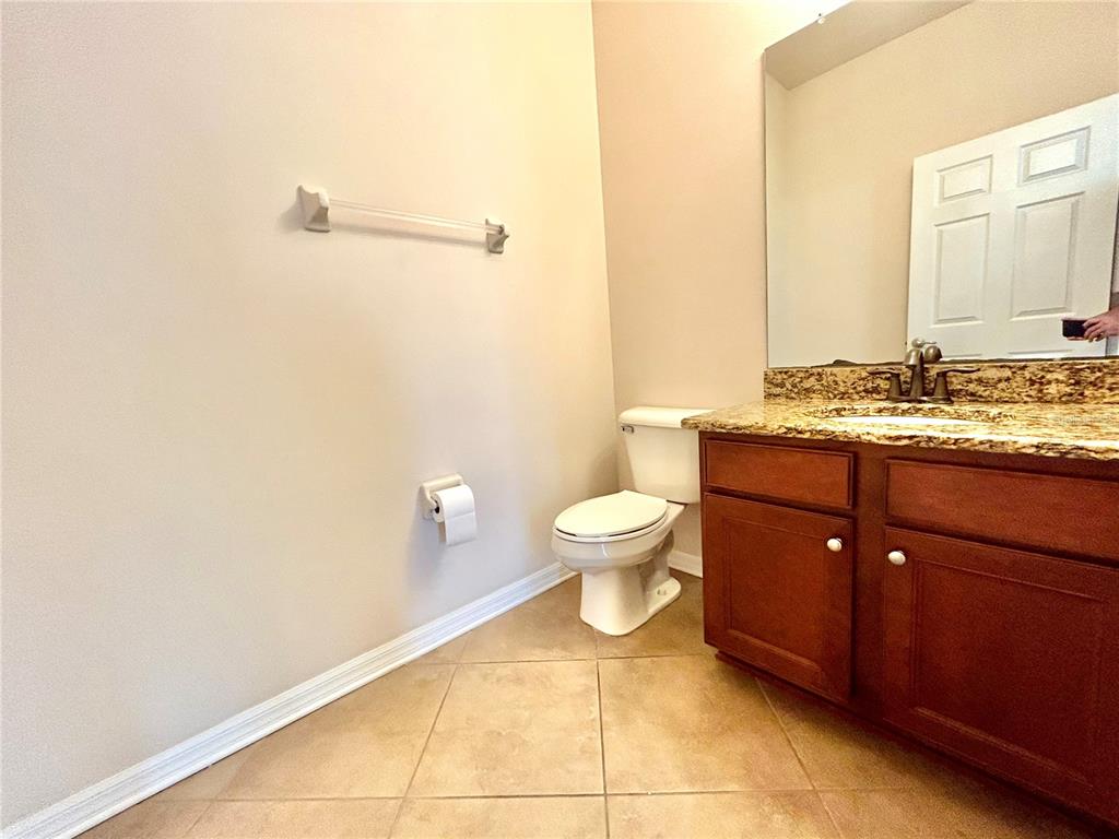 11210 Roseate Drive Tampa, FL 33626 - Photo 34 of 50 a bathroom with a toilet a sink and mirror