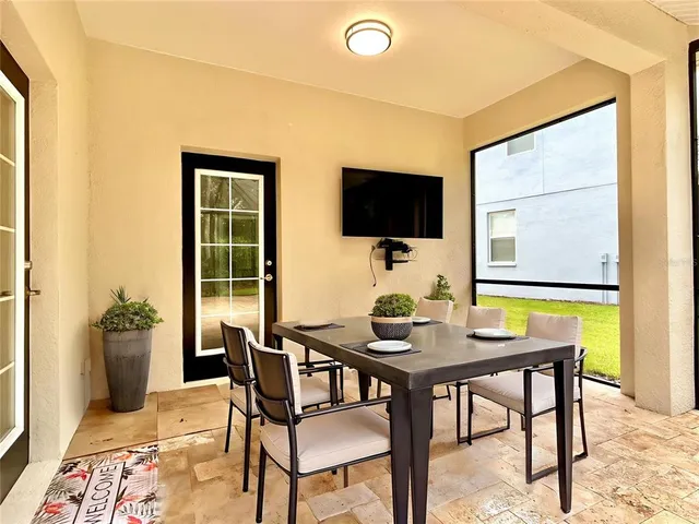 a work room with furniture and a flat screen tv