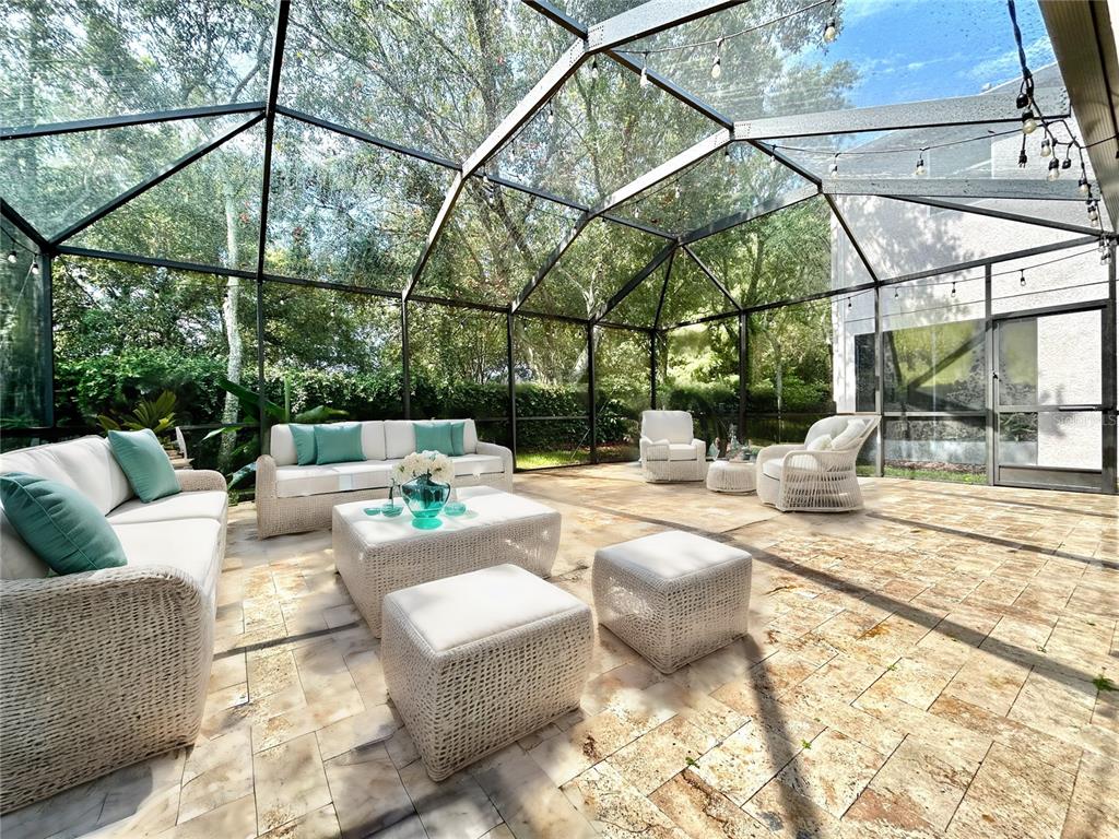 11210 Roseate Drive Tampa, FL 33626 - Photo 39 of 50 a view of a swimming pool with couches and wooden floor