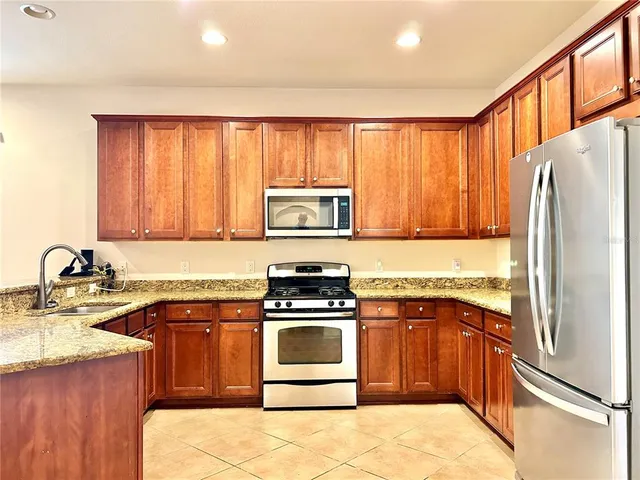 a kitchen with a stove a sink and a refrigerator