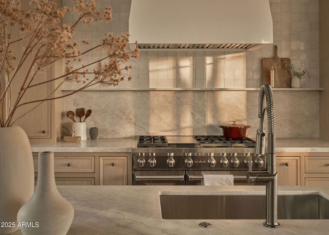 a kitchen with a sink and large window