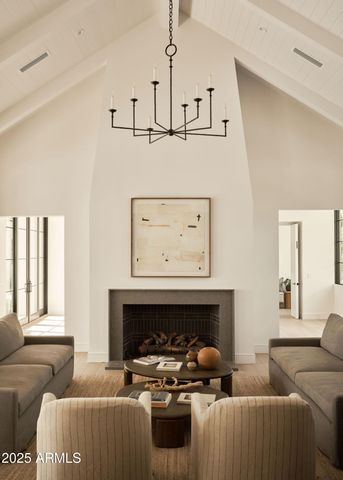 a living room with furniture a fireplace and window