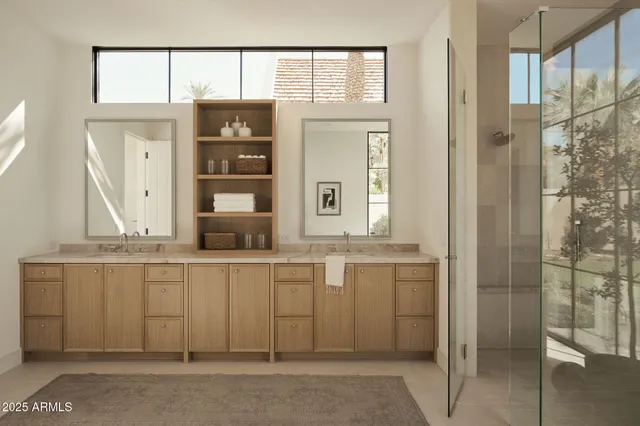 a living room with a large window and furniture