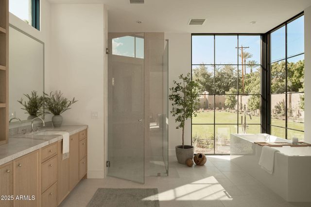 a vase of flowers sitting on a granite counter top