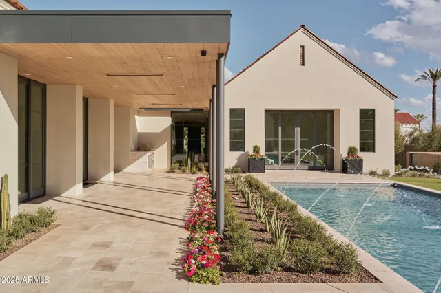 a view of a house with backyard and sitting area