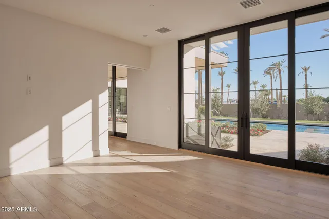 a living room with furniture a flat screen tv and a window