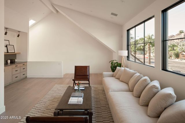a living room with furniture and a floor to ceiling window