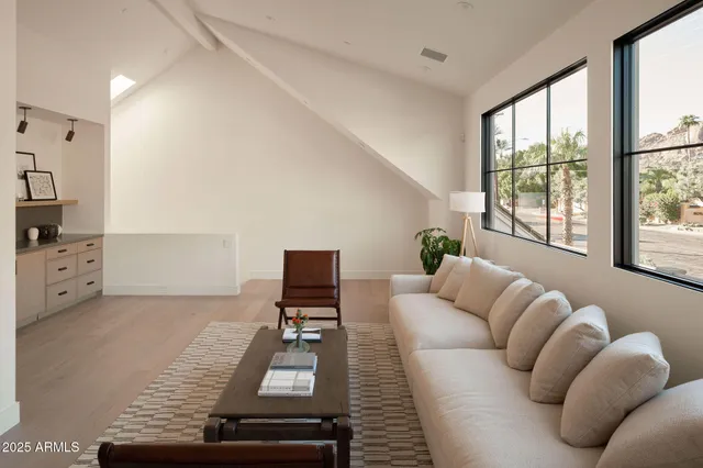 a living room with furniture and a floor to ceiling window