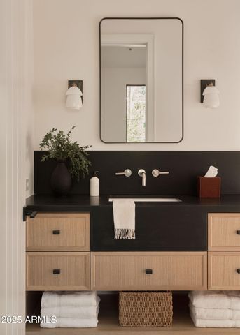 a bathroom with a sink toilet and mirror
