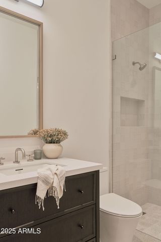 a bathroom with a sink a toilet and mirror