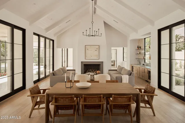 a living room with furniture and large windows