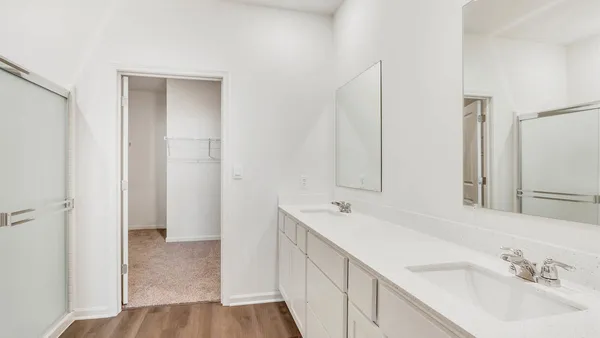 a spacious bathroom with a double vanity sink and a mirror