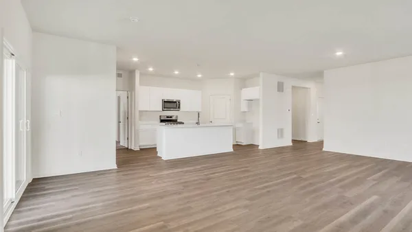 a view of kitchen with kitchen island white cabinets and wooden floor