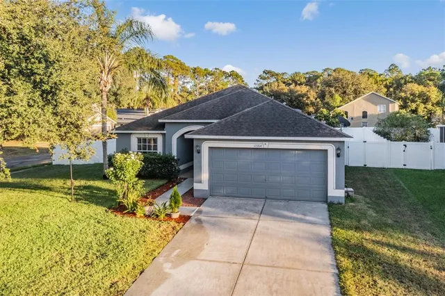 a front view of a house with a yard and garage