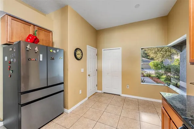 a kitchen with granite countertop a stove a sink and a refrigerator
