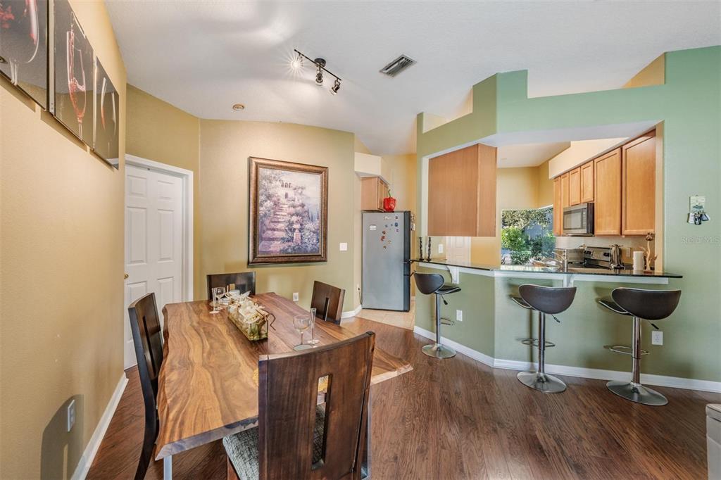 12204 Luftburrow Lane Hudson, FL 34669 - Photo 17 of 33 a view of a dining room with furniture and a floor to ceiling window