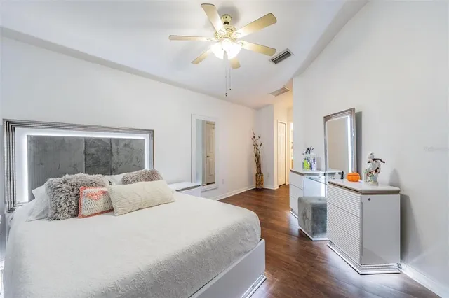 a bedroom with a bed and a chair