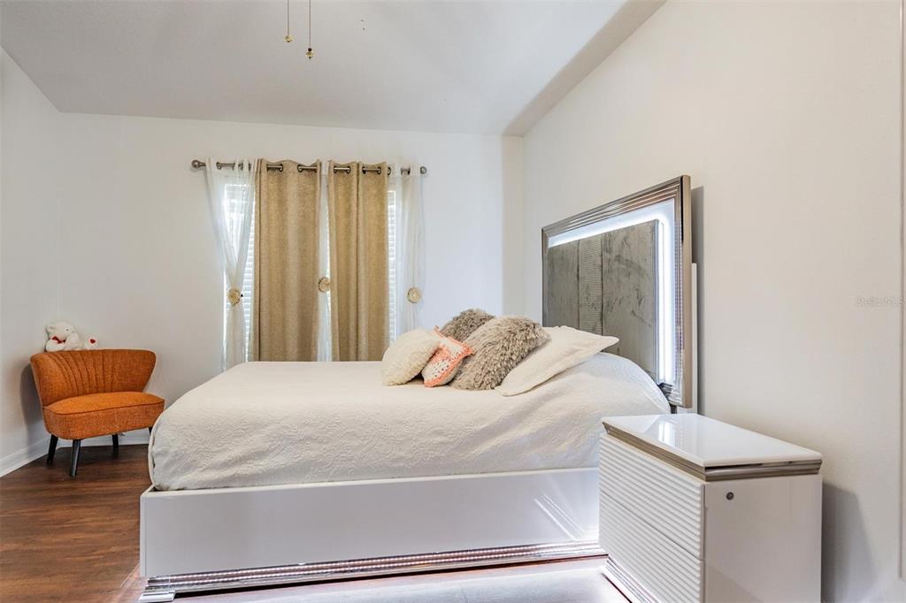 12204 Luftburrow Lane Hudson, FL 34669 - Photo 20 of 33 a bedroom with a bed and a chair