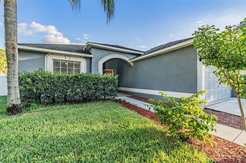 12204 Luftburrow Lane Hudson, FL 34669 - Photo 2 of 33 a front view of a house with garden