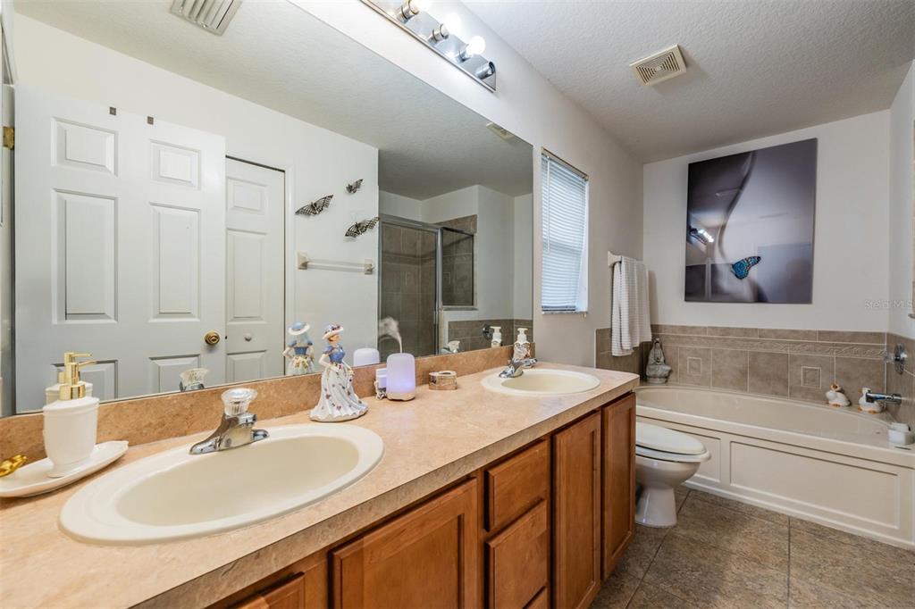 12204 Luftburrow Lane Hudson, FL 34669 - Photo 22 of 33 a bathroom with double vanity sinks and a mirror