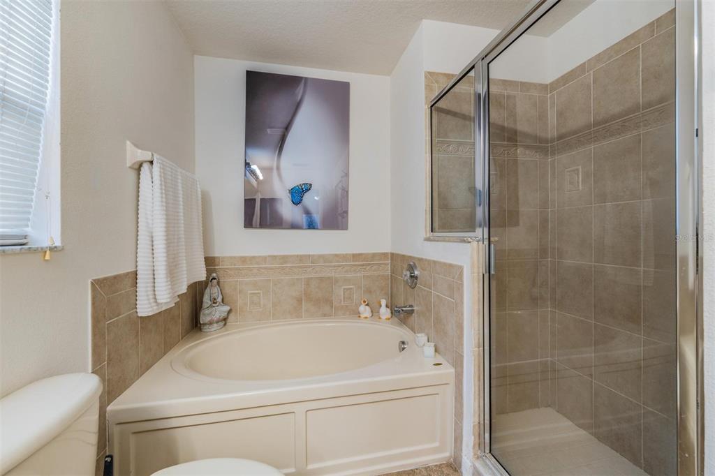 12204 Luftburrow Lane Hudson, FL 34669 - Photo 23 of 33 a bathroom with a tub and a shower