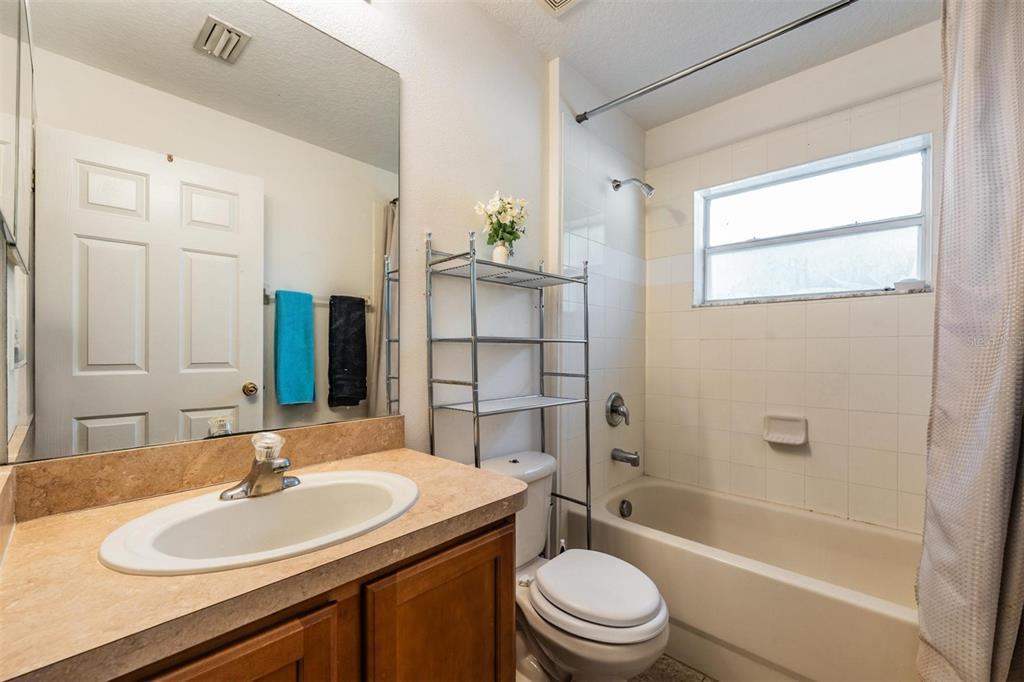 12204 Luftburrow Lane Hudson, FL 34669 - Photo 27 of 33 a bathroom with a sink toilet and shower