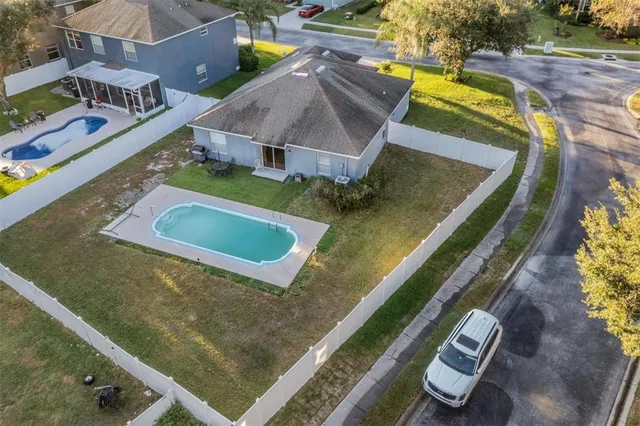 an aerial view of residential houses with outdoor space