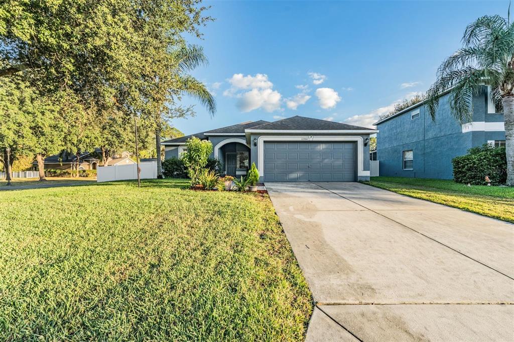 12204 Luftburrow Lane Hudson, FL 34669 - Photo 33 of 33 a front view of a house with garden