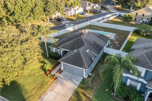 an aerial view of a house with a yard