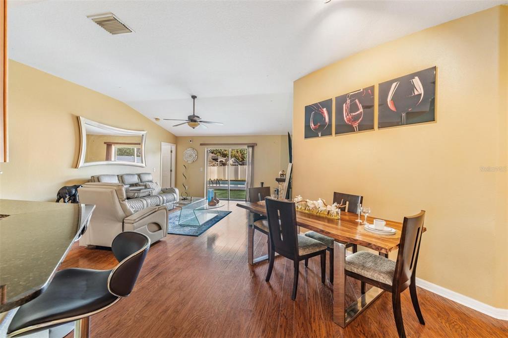 12204 Luftburrow Lane Hudson, FL 34669 - Photo 8 of 33 a view of a dining room with furniture window and wooden floor