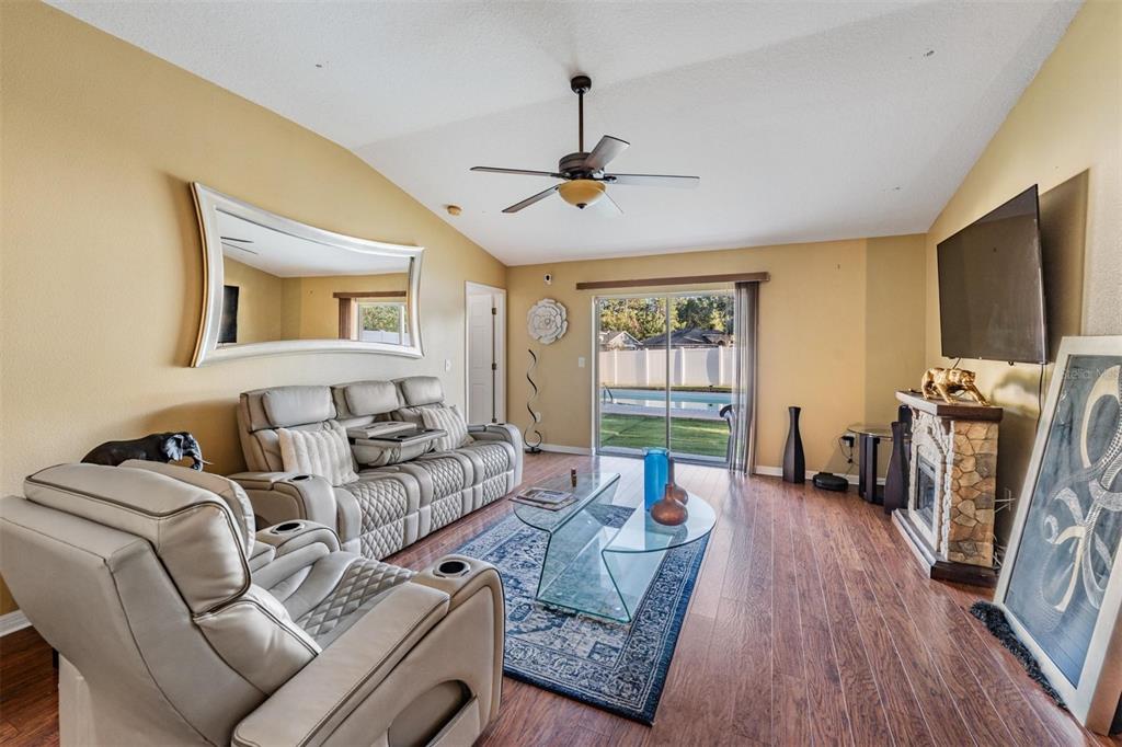 12204 Luftburrow Lane Hudson, FL 34669 - Photo 9 of 33 a living room with furniture a flat screen tv and a window