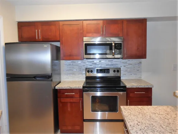 a kitchen with a refrigerator stove and microwave