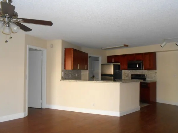 a kitchen with stainless steel appliances a refrigerator and a stove top oven