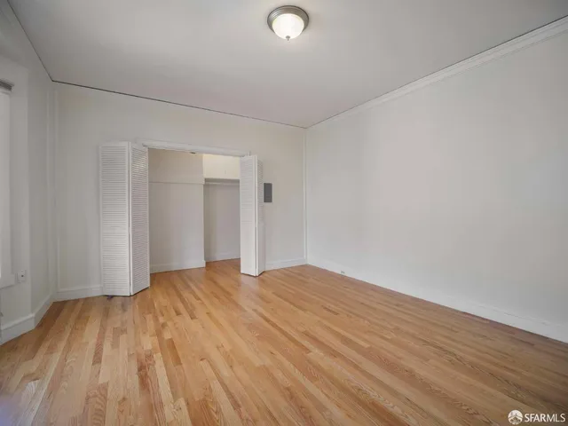 a view of an empty room and wooden floor