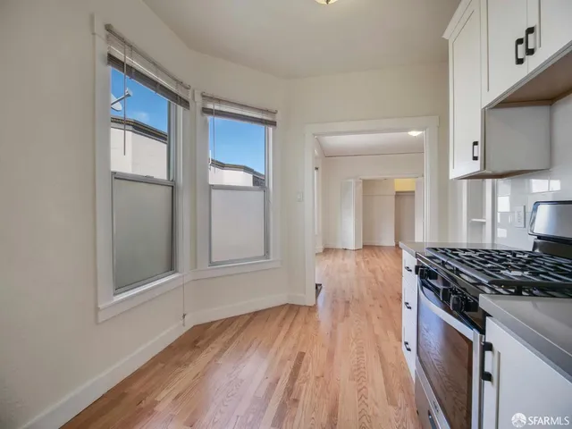 a kitchen with wooden floors and a stove