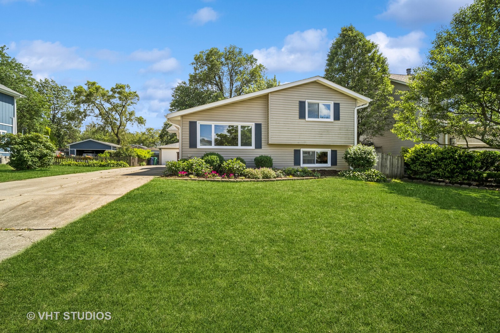 221 West Harrison Road Lombard, IL 60148 - Photo 2 of 24 a view of a house with a big yard and large trees