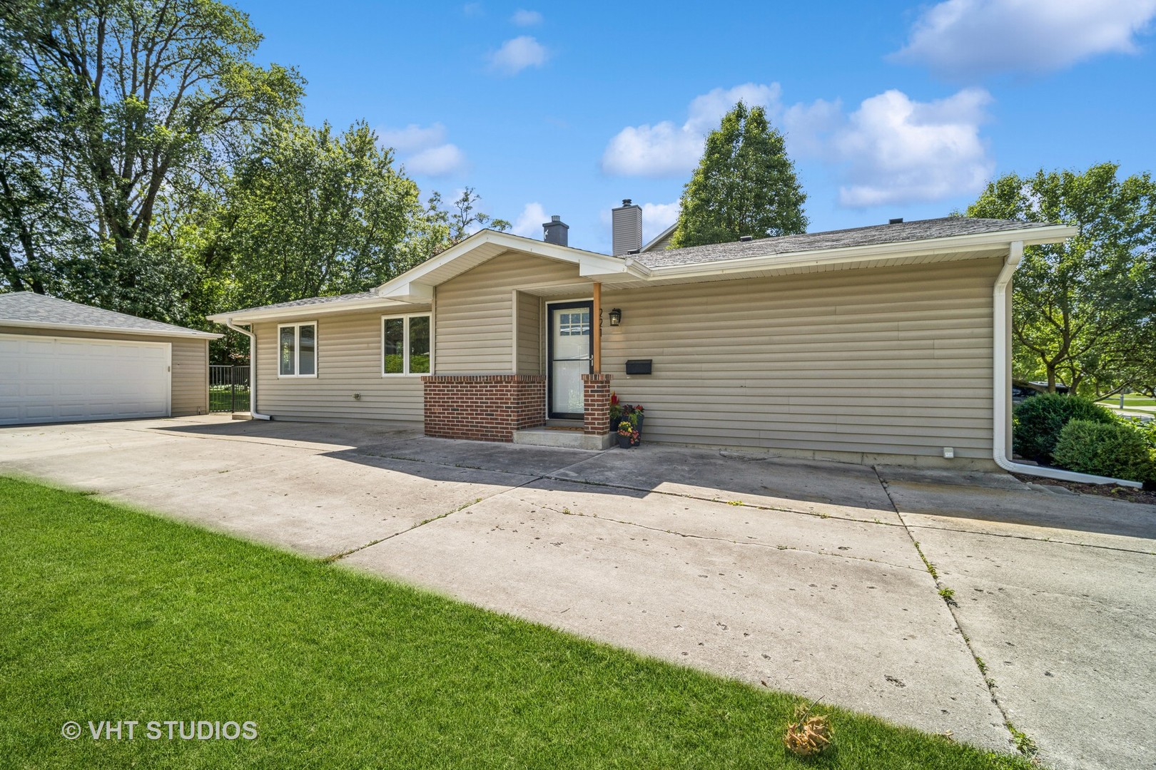 221 West Harrison Road Lombard, IL 60148 - Photo 3 of 24 a front view of a house with a yard and garage