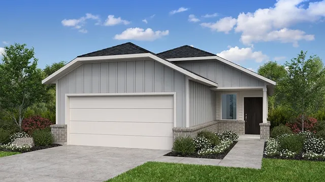 a white house with a small yard and garage