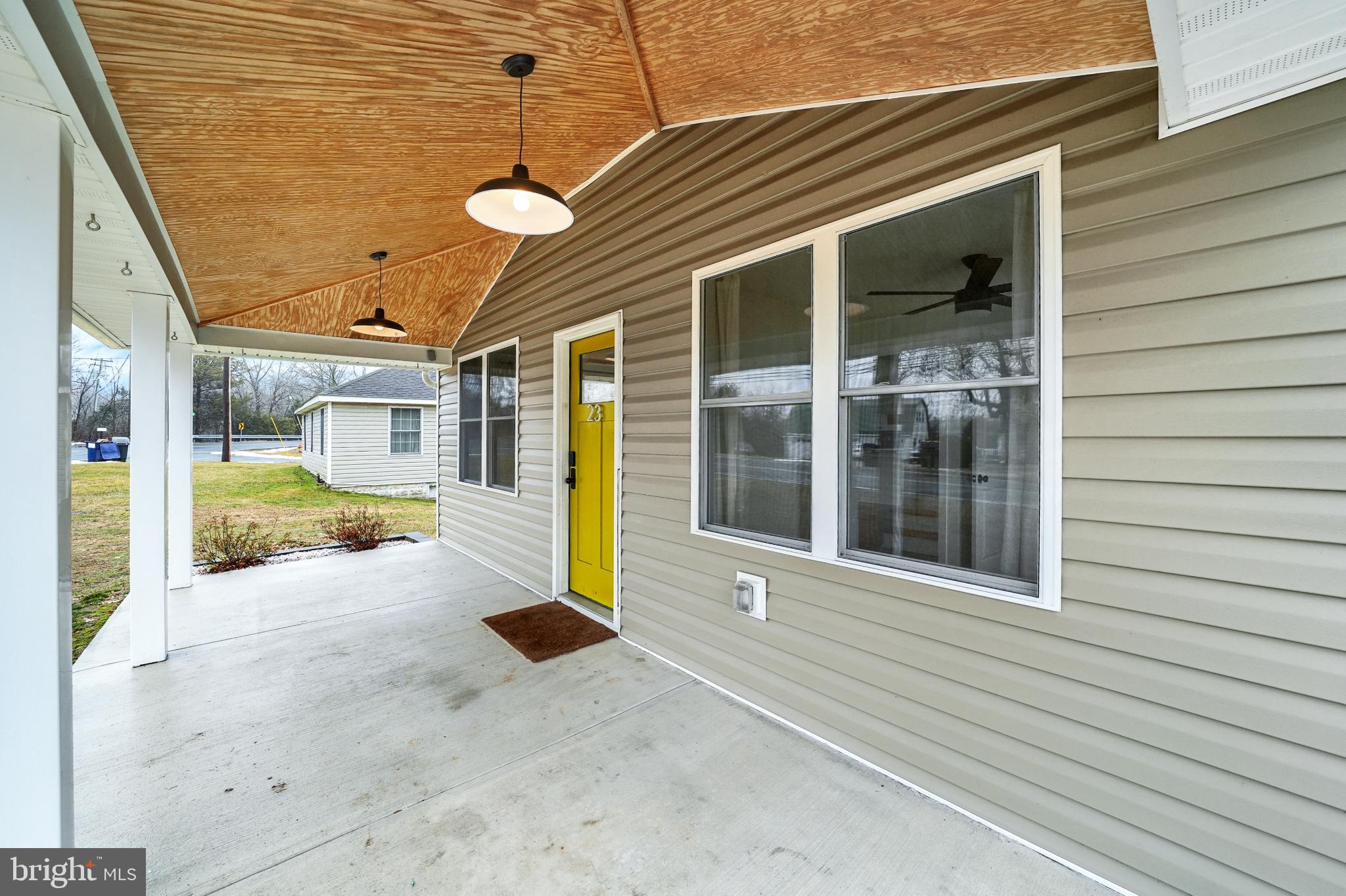 23 Old Bayview Road North East, MD 21901 - Photo 3 of 32 Charming entryway with vibrant yellow door.