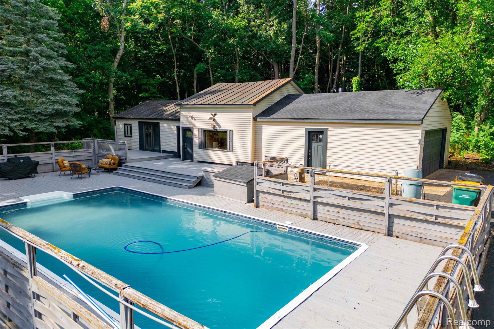 4860 Blue Bush Road Monroe, MI 48162 - Photo 43 of 59 Outdoor swimming pool with integrated steps, surrounded by a multi-level deck