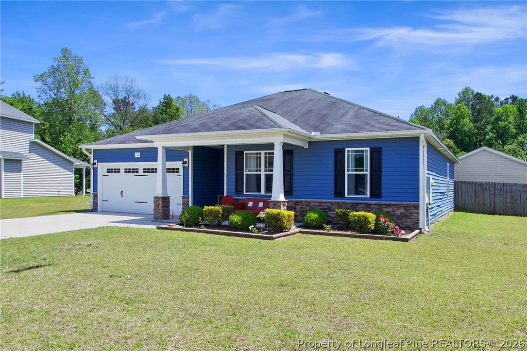 216 Meherrin Loop Raeford, NC 28376 - Photo 2 of 38 a front view of a house with a yard and garage